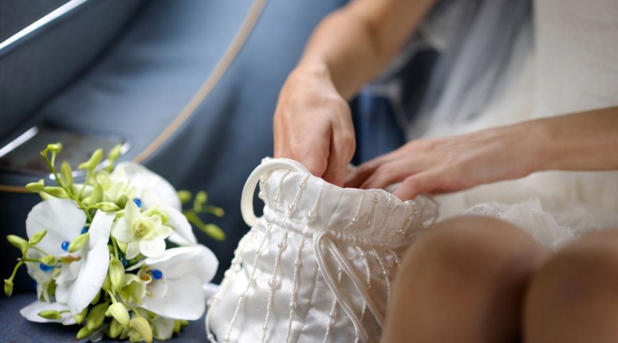 The idea of wearing a handbag as part of your attire at a wedding in the UK